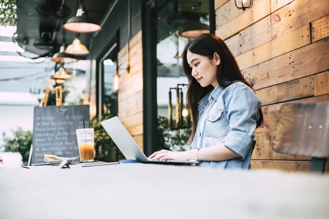 iStock-950156626 Woman working on laptop at coffee shop